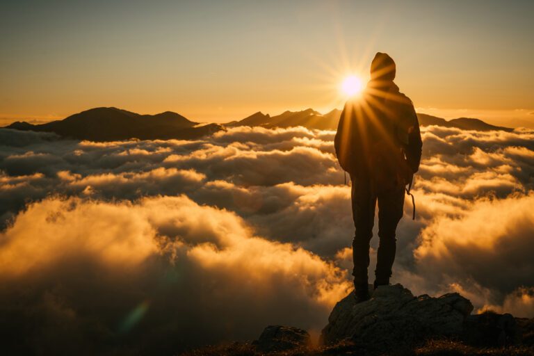 hiker mountain top sunset